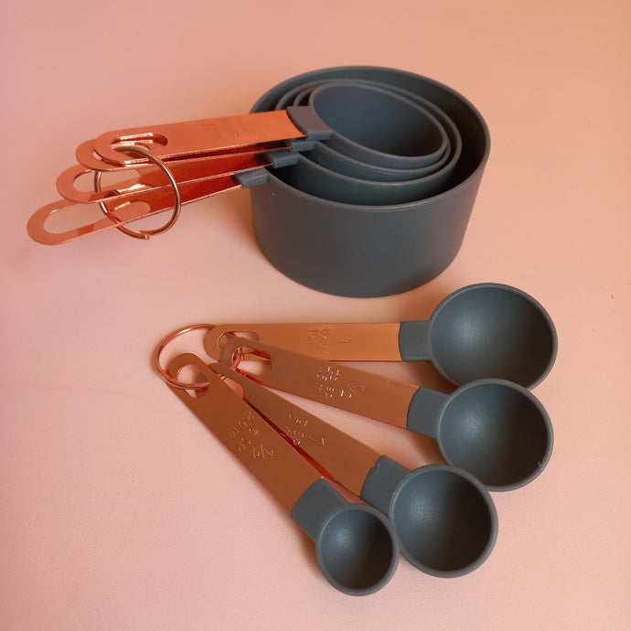 grey and rose gold measuring cups and spoons