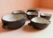 Load image into Gallery viewer, Six stacking ceramic bowls with white inside and matt black outside

