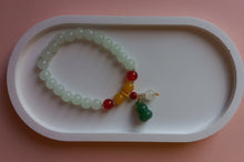 Load image into Gallery viewer, White, amber and red stone beaded bracelet with green lucky charm and bead. 
