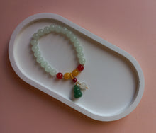 Load image into Gallery viewer, White, amber and red stone beaded bracelet with green lucky charm and bead. 
